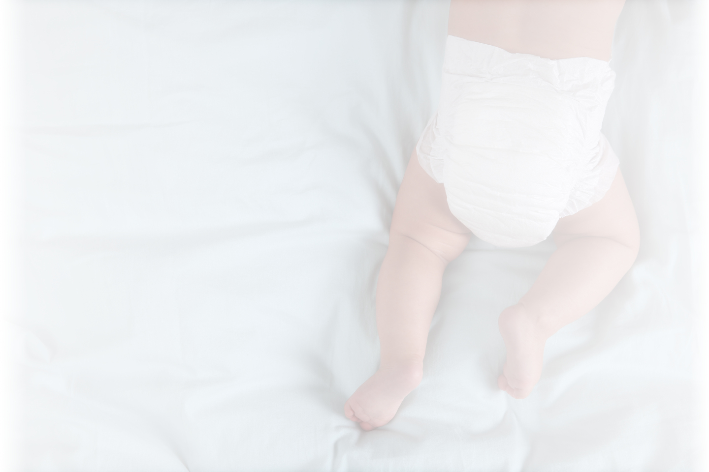 A baby in clean white diaper